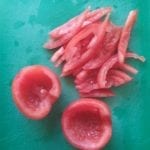 Snijplank met uitgeholde en in reepjes gesneden tomaten